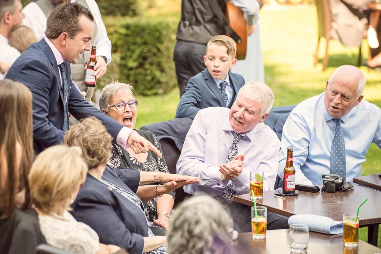 Magician James Maidment making guests laugh at a wedding in the Italian Villa Dorset