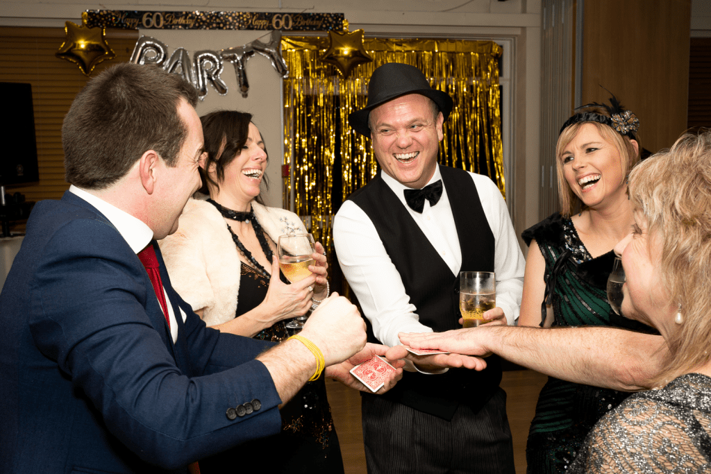 Party Magician has guests laughing at his amazing and funny magic during the evening party